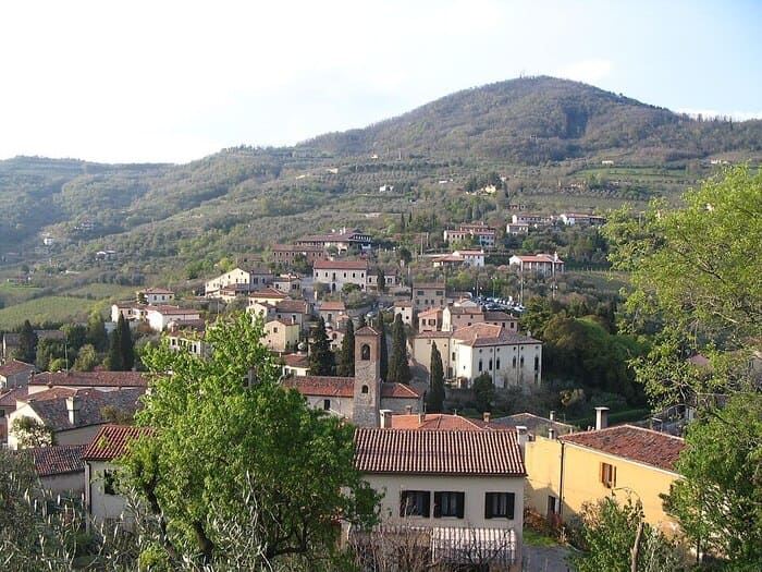 Panoramica di Arquà Petrarca: borgo medievale tra i vigneti e gli ulivi dei Colli Euganei, tra tetti in cotto e antichi campanili.